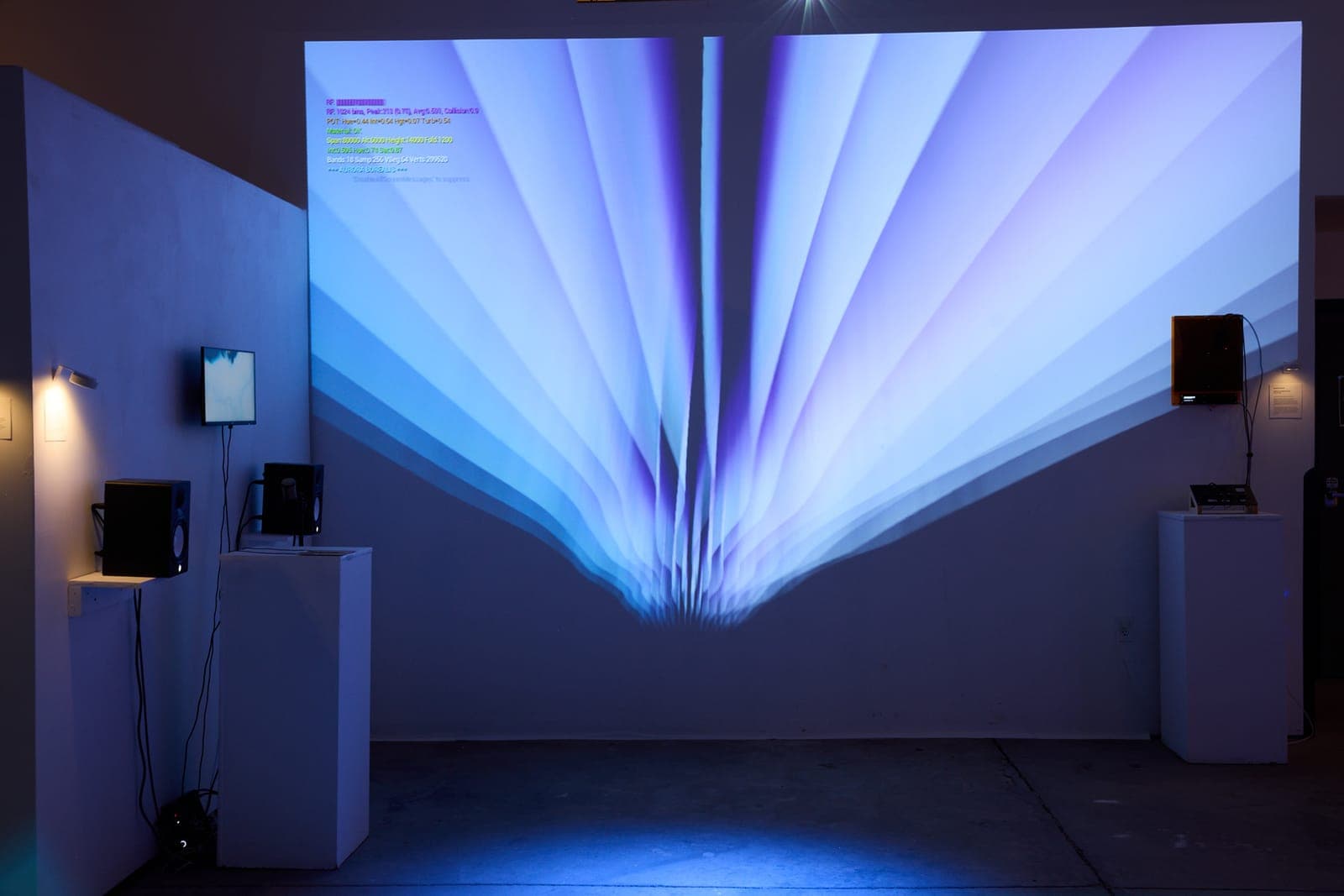 A fan of pale blue projected light unfolding across a gallery wall beside speakers and a sensor pedestal