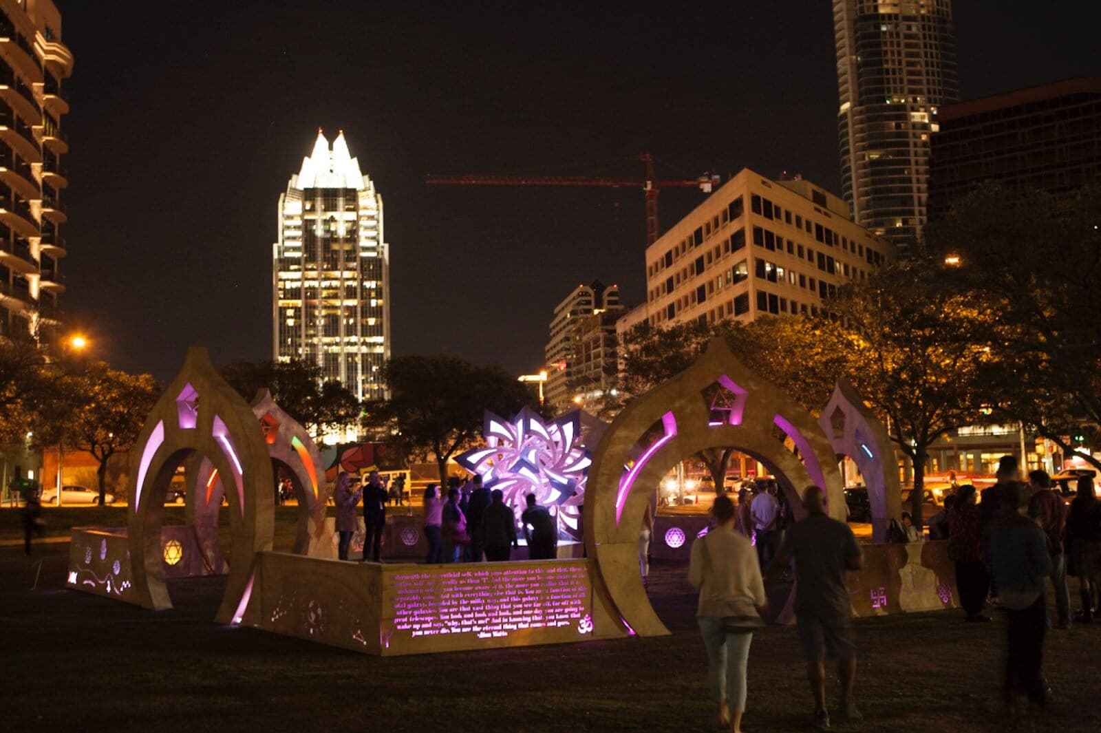 The portals and star sculpture installed in downtown Austin at night during SXSW Interactive 2014, Frost Bank Tower behind