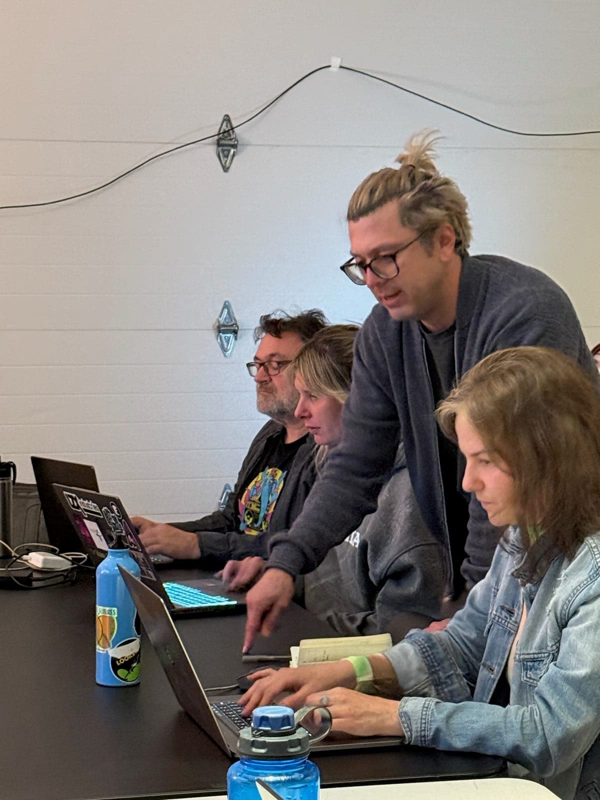 Artists working side by side on laptops during a hands-on session